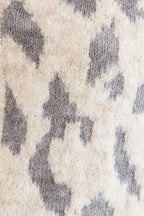 Close-up of a leopard print sweater cardigan. 