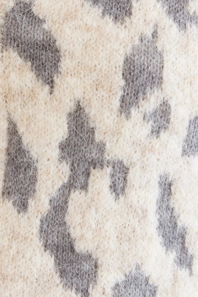 Close-up of a leopard print sweater cardigan. 