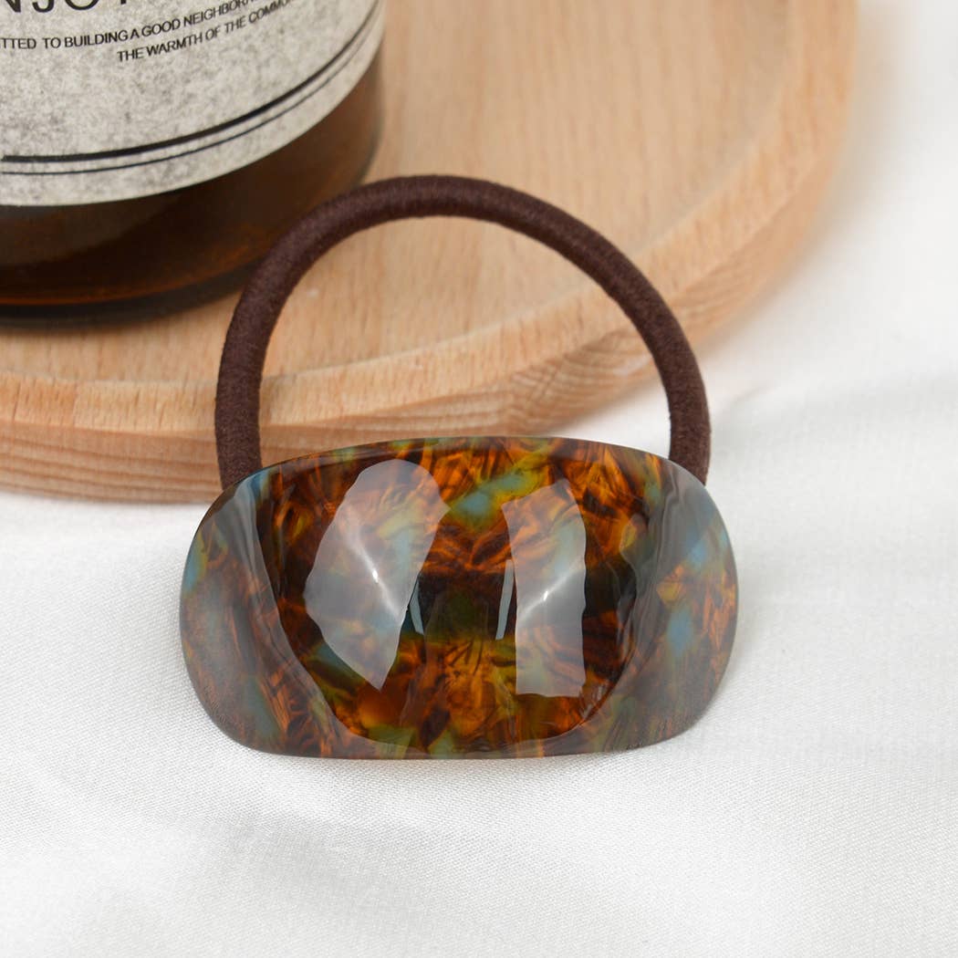 Brown/Blue resin hair tie on a white background