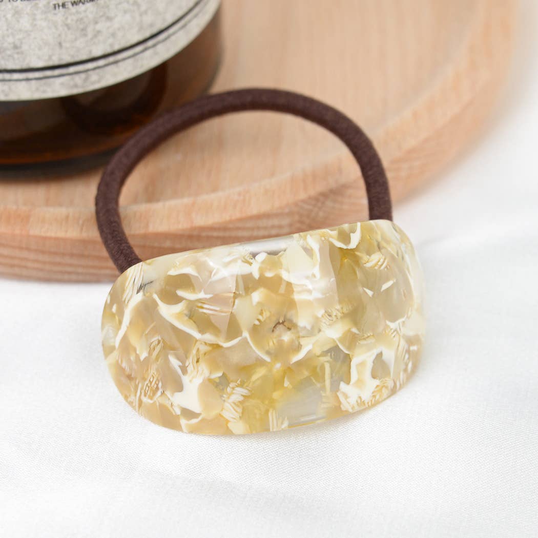 Tan marble resin hair tie on white background