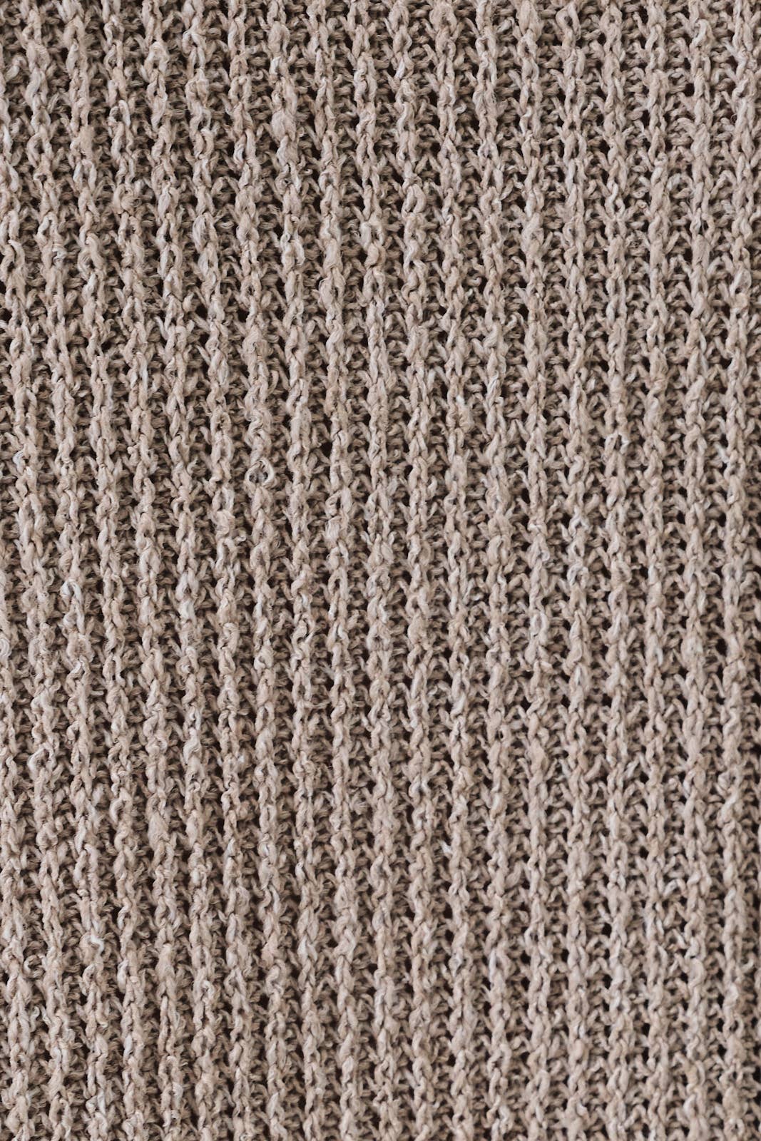 Close-up of a oatmeal boucle  fabric with a ribbed pattern