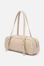 Nude slim baquette shoulder handbag with croco pattern on a white background