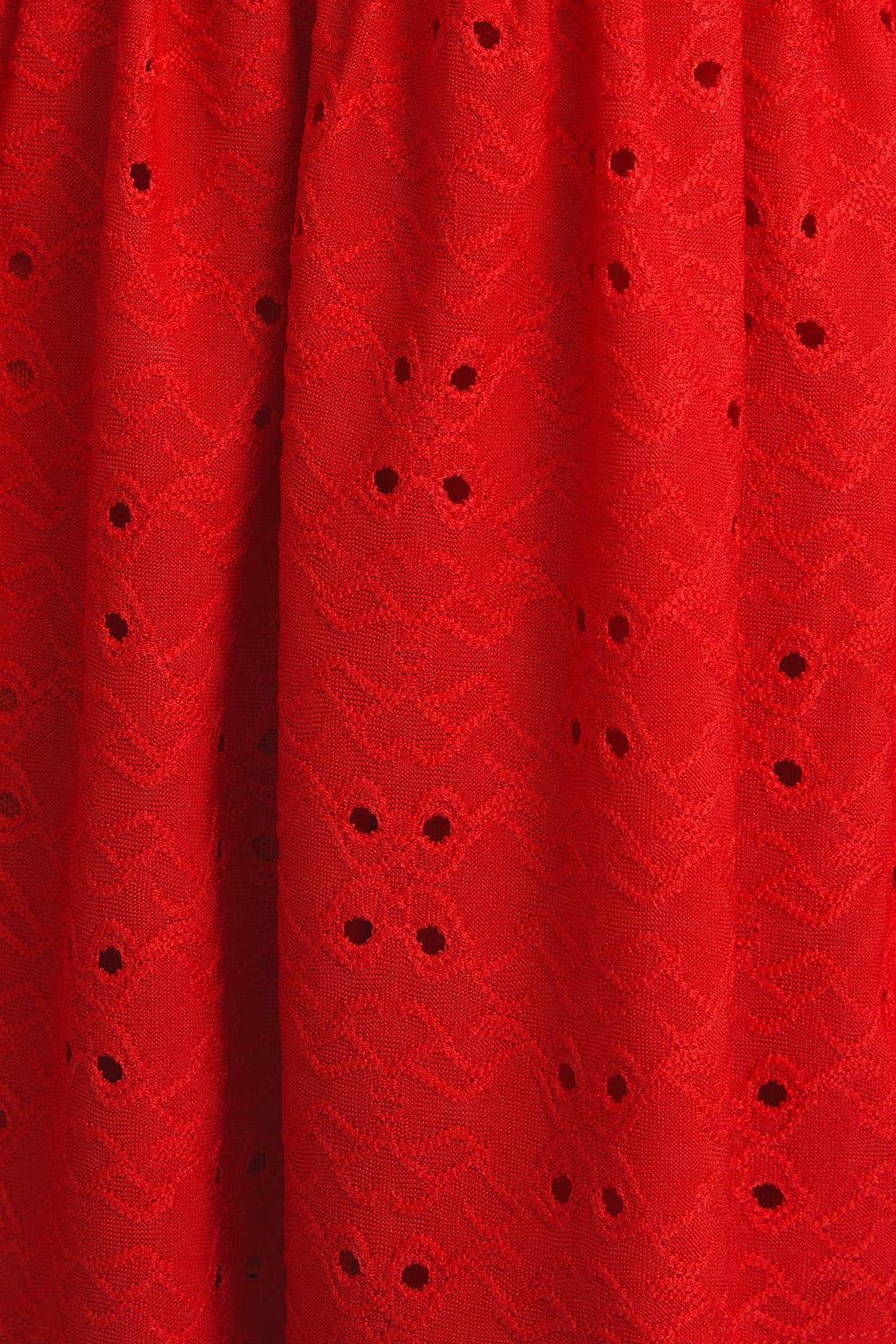 Close up of red eyelet fabric