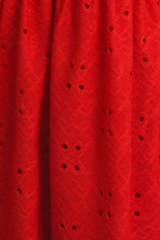 Close up of red eyelet fabric