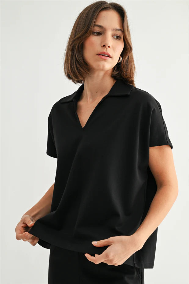 Woman wearing a black shirt against a plain background