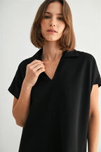 Woman wearing a black ponte shirt against a plain background