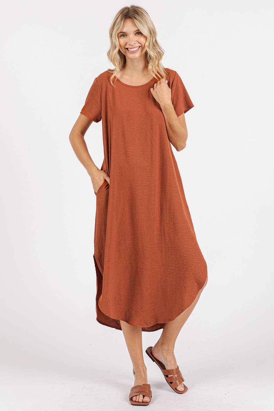 Woman wearing a copper midi dress with short sleeves on a white background