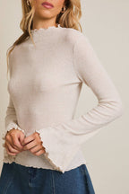 Oatmeal mock neck ribbed knit top with flared sleeves and wavy stitching plain background