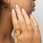 Woman wearing an oval motif gold ring