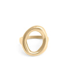 Gold ring with an oval motif design on a white background