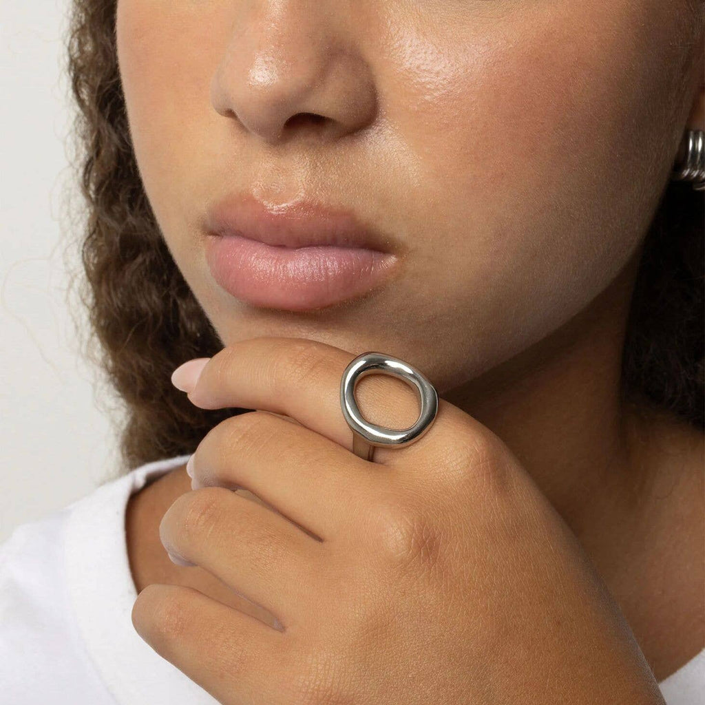 Woman wearing oval silver-plated stainless steel ring
