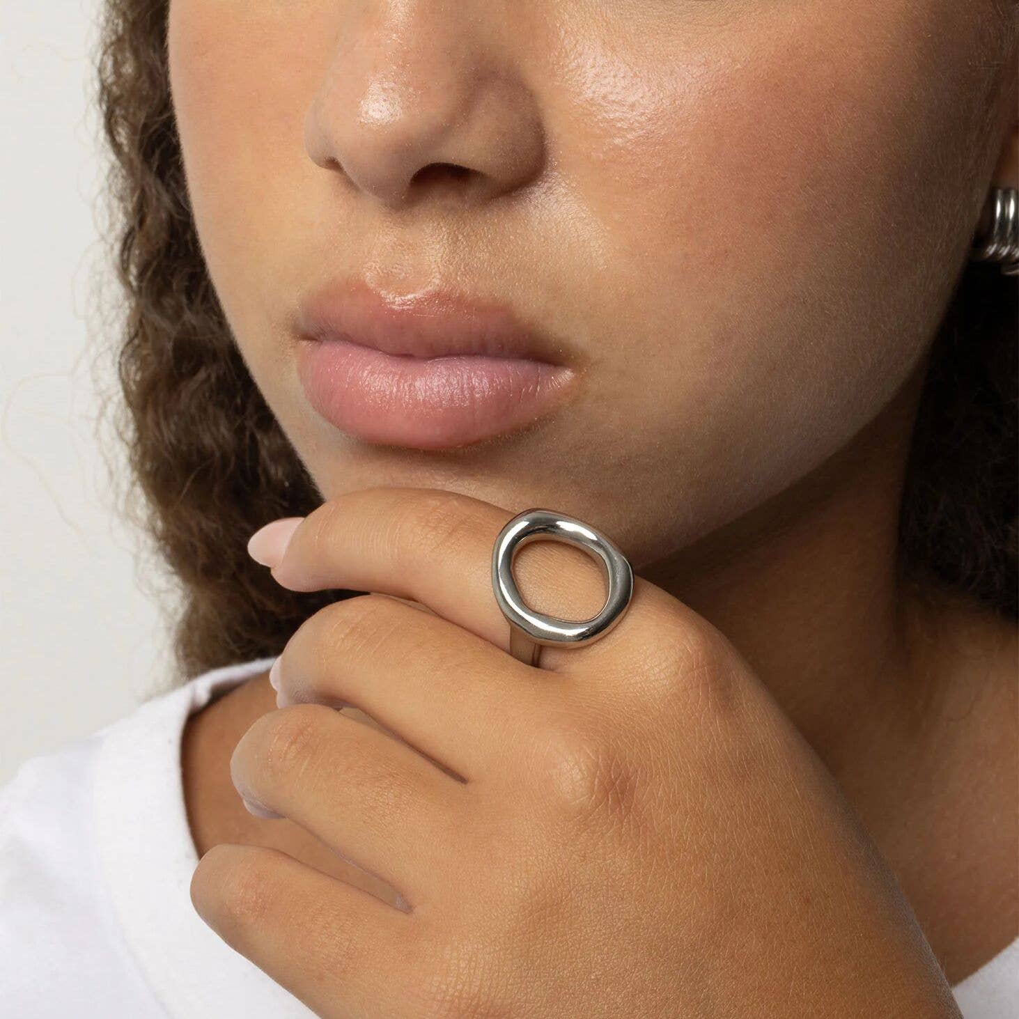 Woman wearing oval silver-plated stainless steel ring