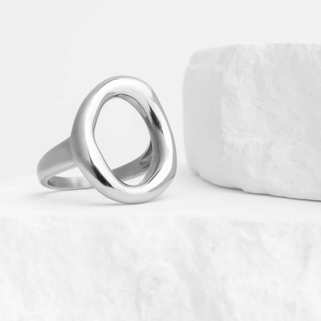 Oval silver plated stainless steel ring on white background