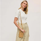 Woman with a tan cell phone wallet crossbody against a white background