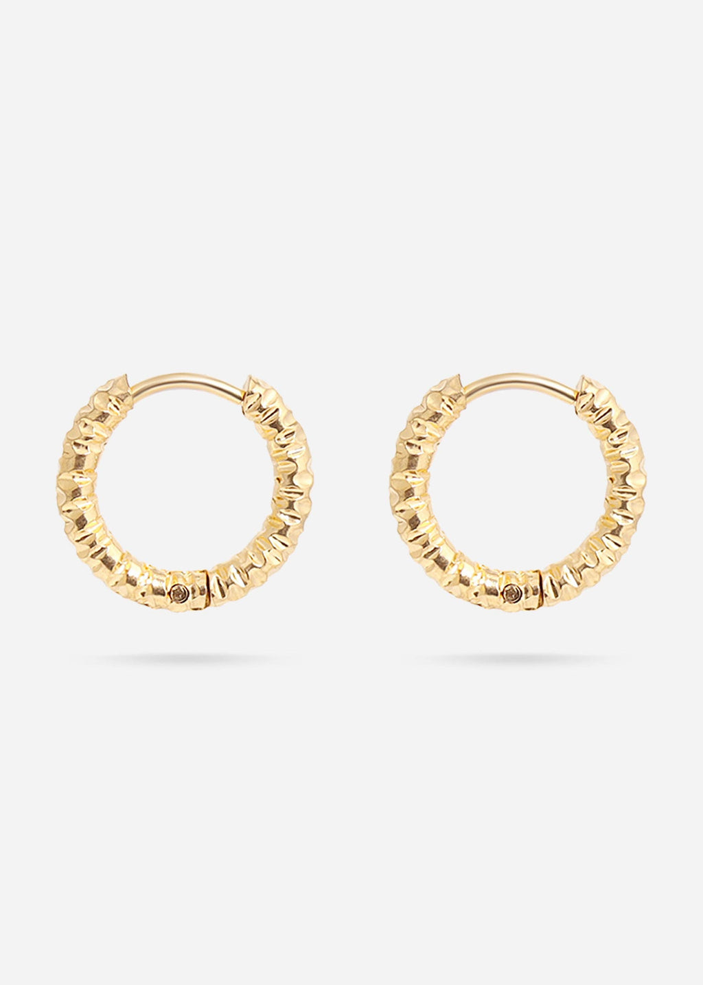 Gold huggie hoop earrings on a white background