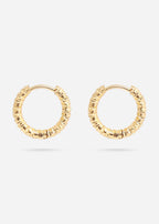 Gold huggie hoop earrings on a white background