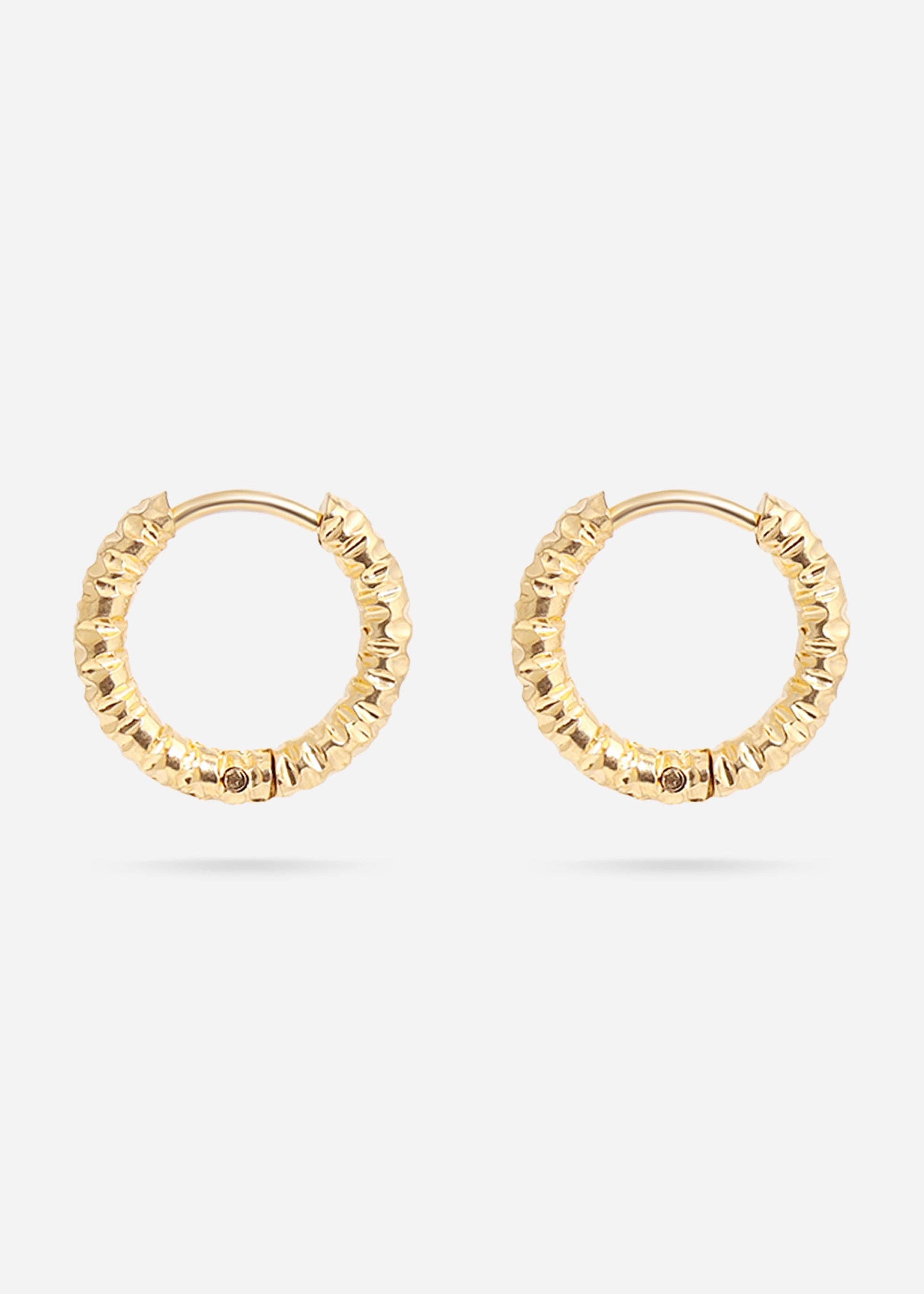Gold huggie hoop earrings on a white background