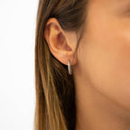 Woman wearing silver textured hoop earring