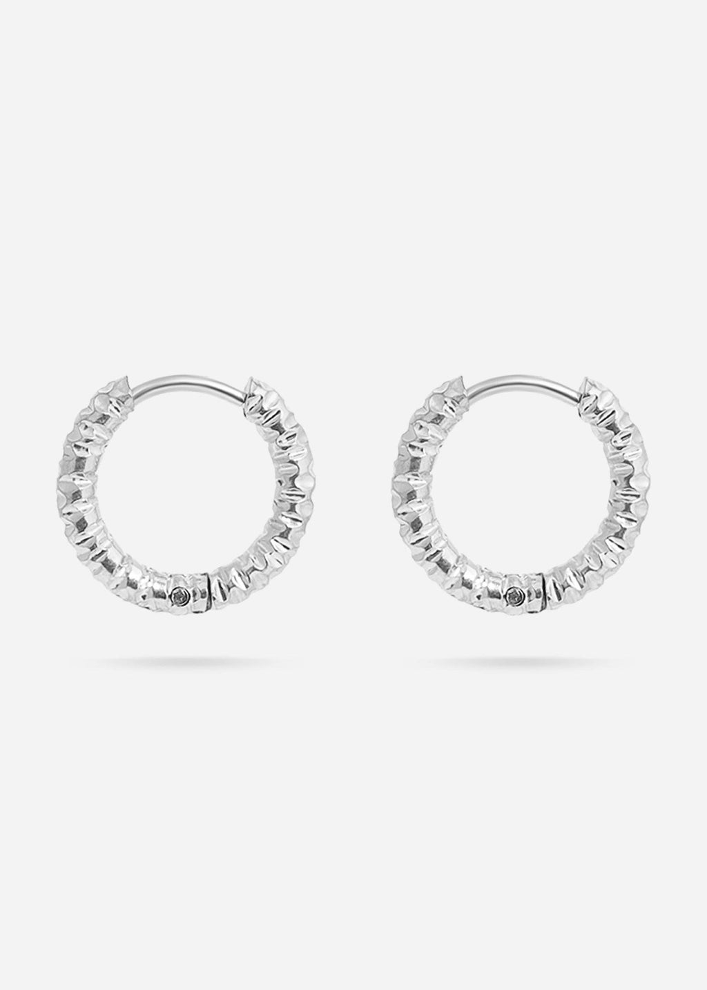 Pair of silver textured hoop earrings on a white background