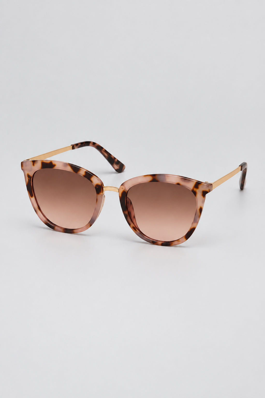 Light tortoise frames with metal side arms against a white background