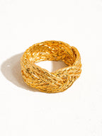 Gold braided ring on a white background
