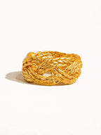 Gold braided ring on a white background