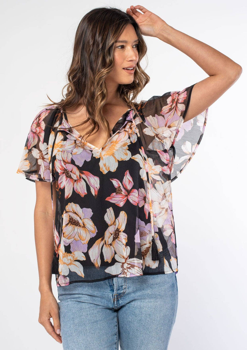 Woman wearing a floral blouse with a plain background