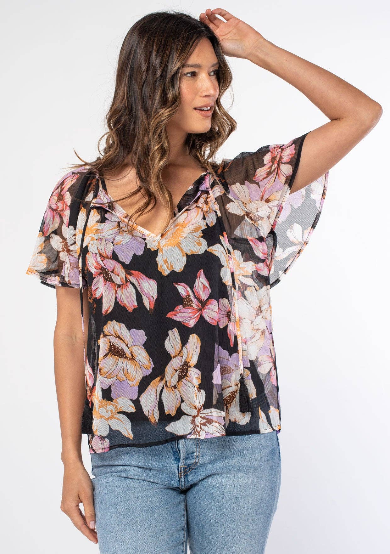 Woman wearing a floral blouse with a plain background
