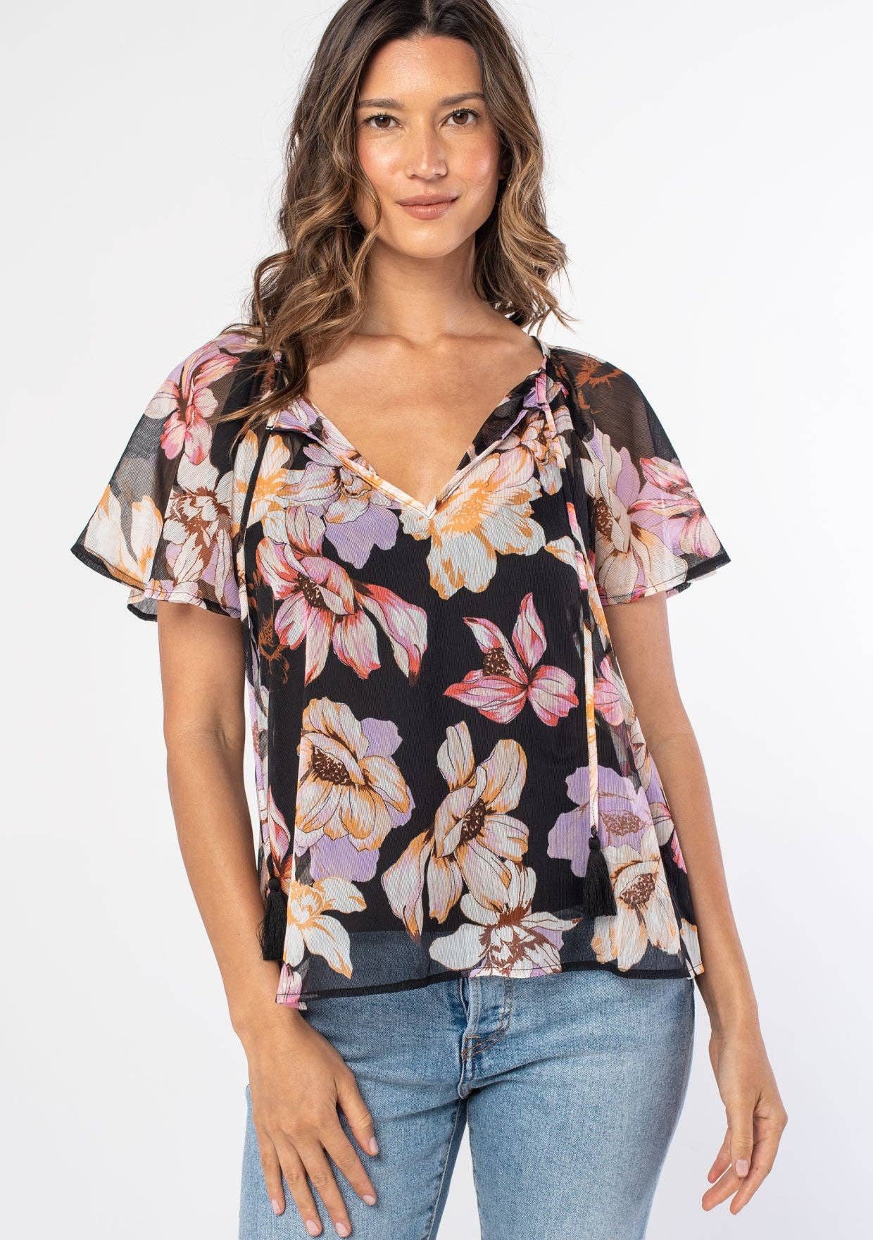 Woman wearing a floral blouse with a plain background
