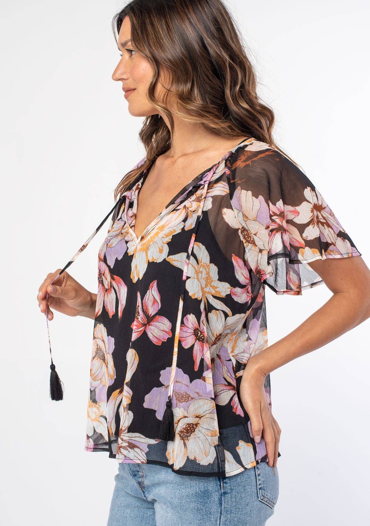 Woman wearing a floral blouse with a plain background