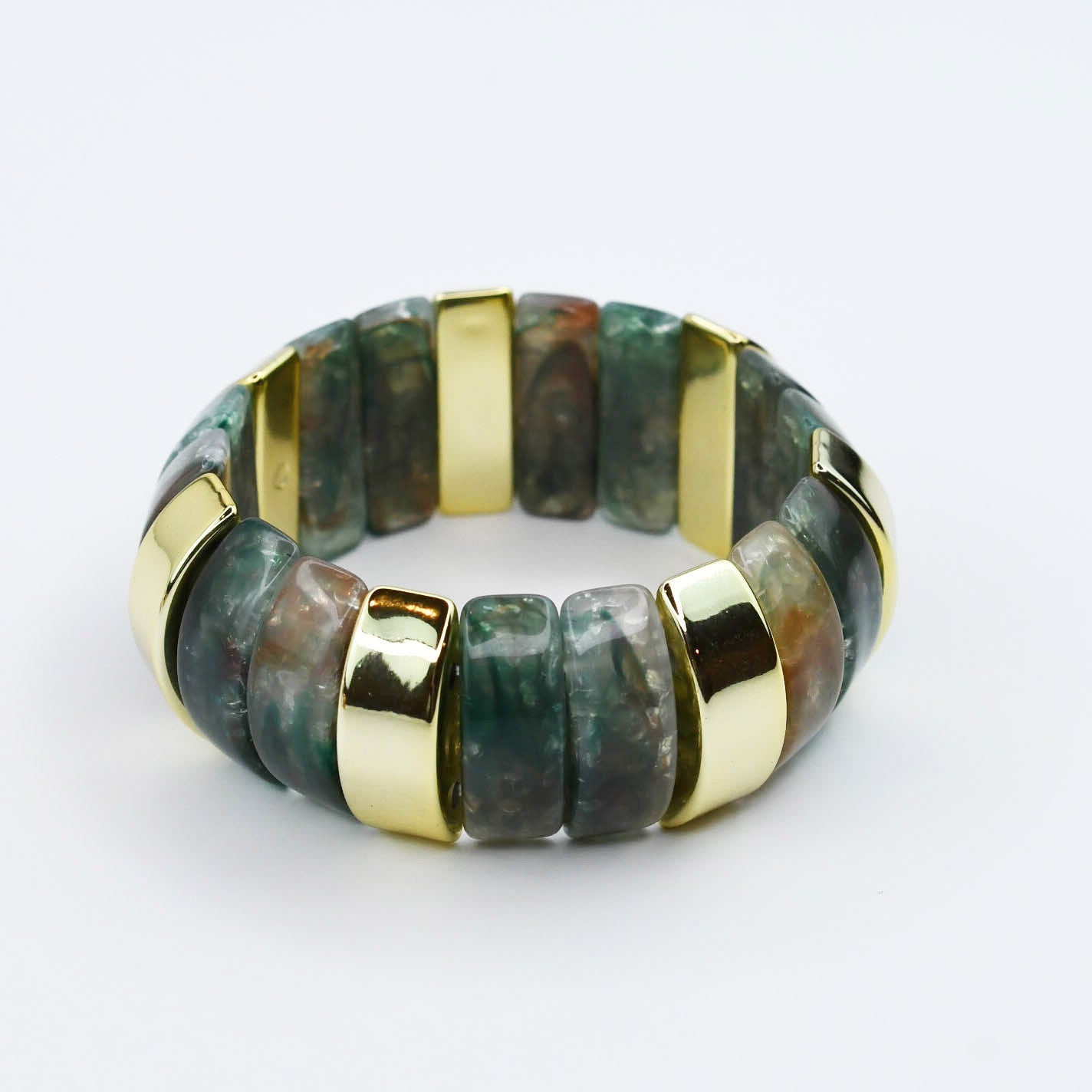 Bracelet with marbled teal green gemstone beads and gold accents on a white background