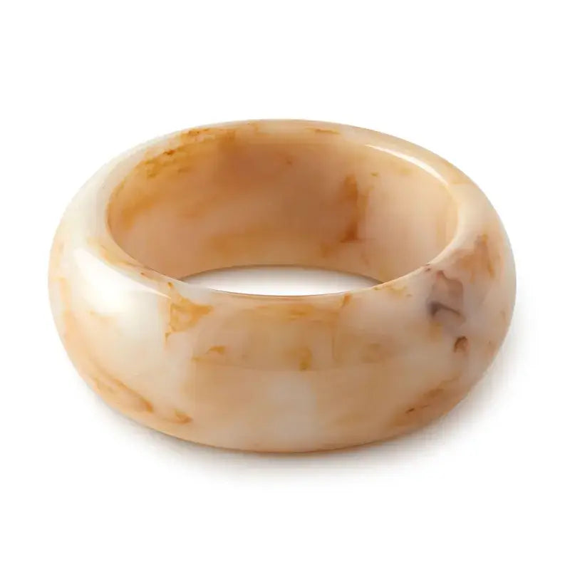 Women's marbled beige and white chunky bracelet on a white background