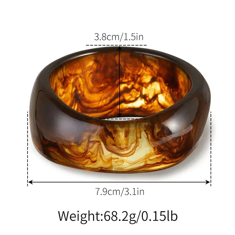 Woman's brown chunky bracelets displayed on a white background