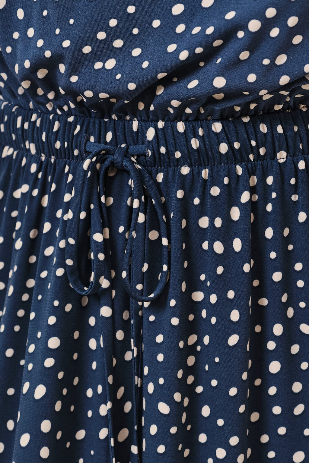 Navy blue dress with ivory polka dots and a tie waist.