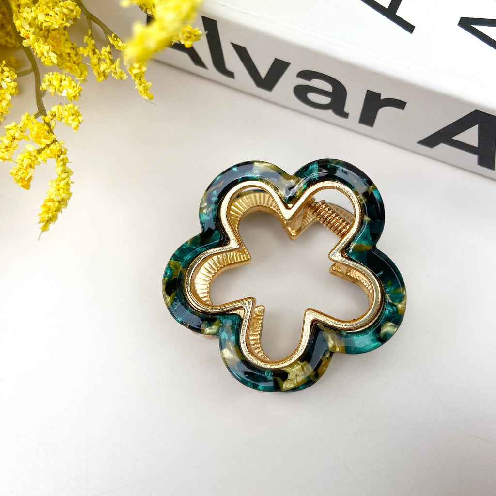 Flower shaped gold hair clip with colorful teal leopard acrylic
