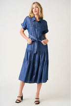 Woman wearing a blue denim dress on a white background