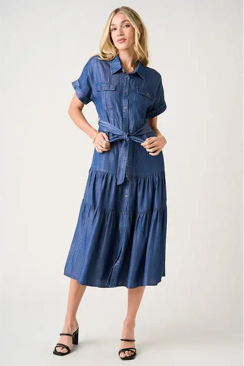 Woman wearing a blue denim dress on a white background
