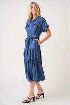 Woman wearing a blue denim dress on a white background