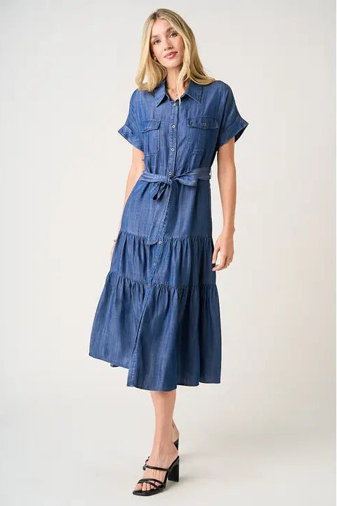 Woman wearing a blue denim dress on a white background