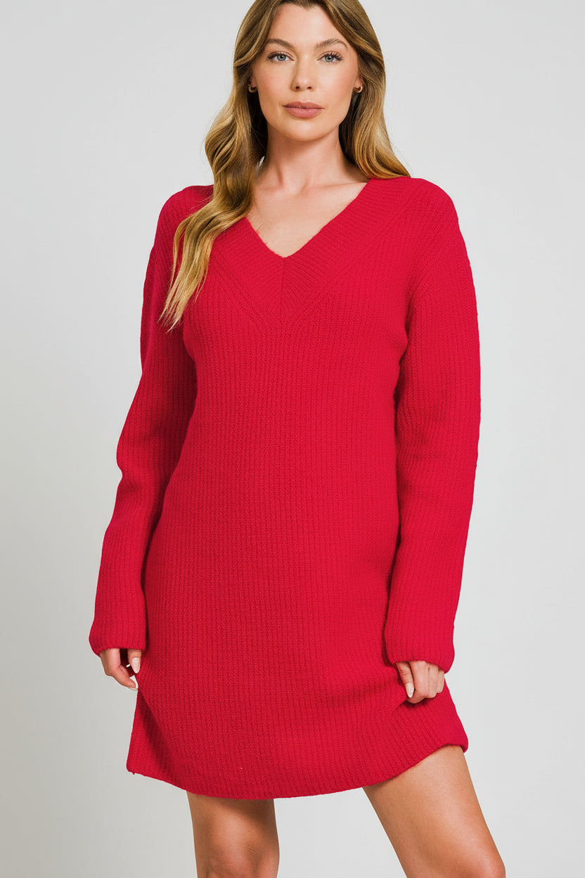 Woman wearing red sweater dress on a white background