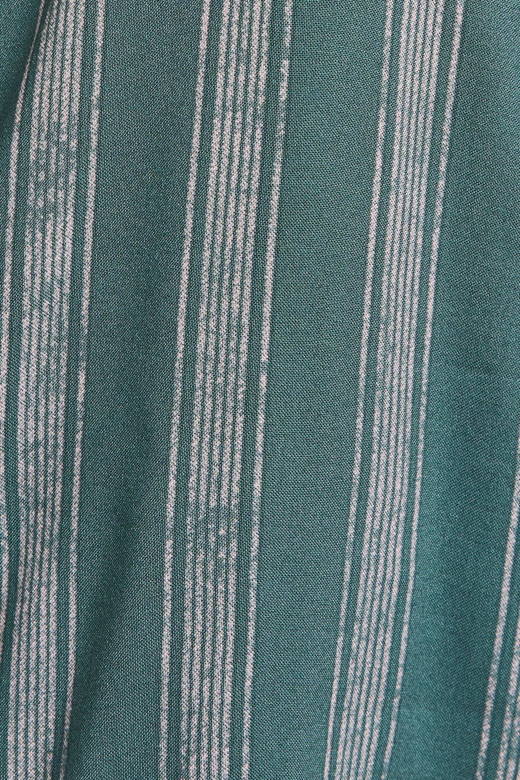 Close up of green and cream striped fabric 