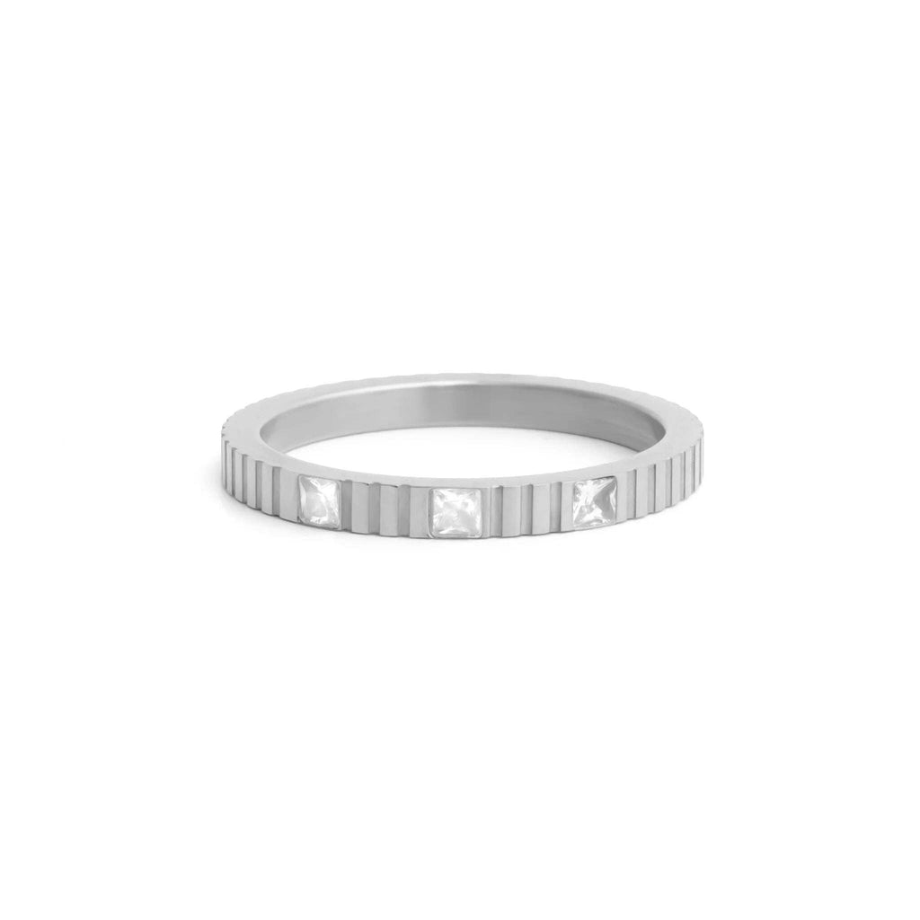 Silver fluted ring with embedded CZ stones on a on a white background