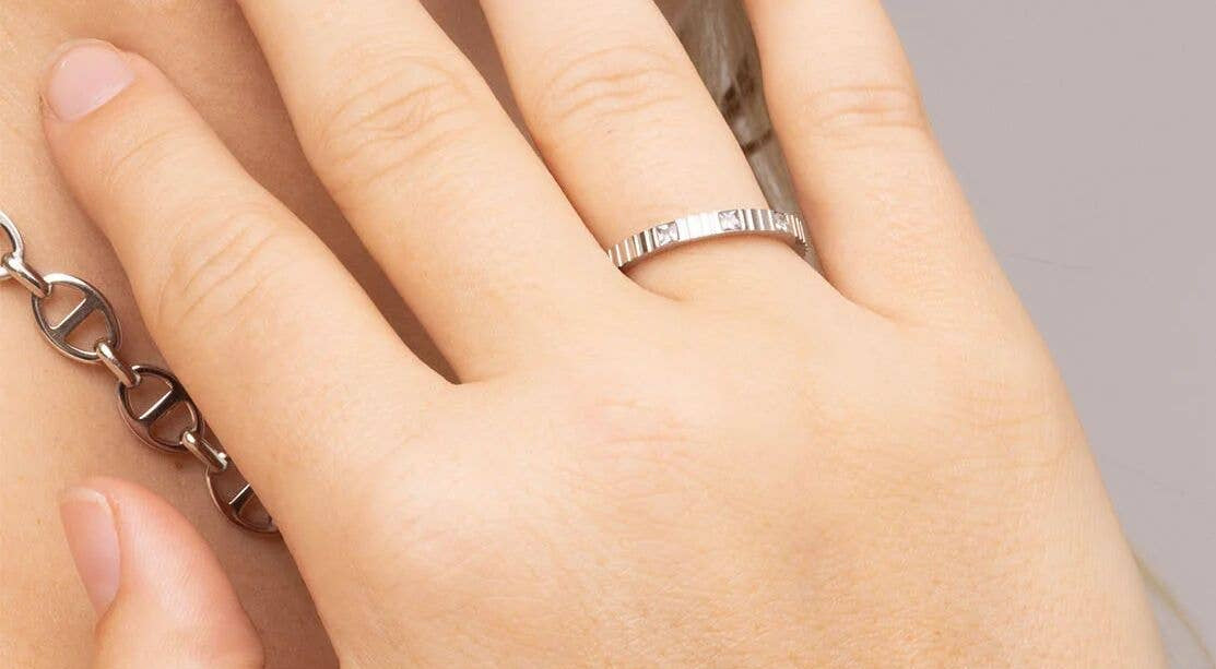 Woman wearing triple stone fluted stacing ring