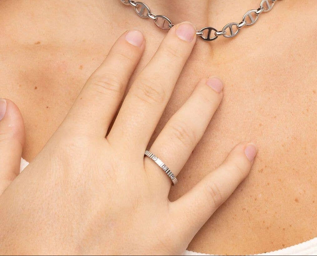 Woman wearing a triple CZ stone fluted band ring