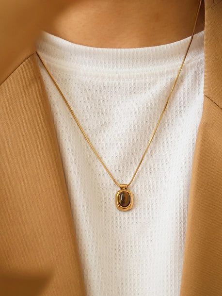Gold box chain necklace with a brown natural stone pendant