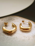 18k gold-plated puffy hoop earrings on whilte stones