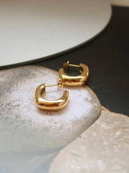 18k gold-plated puffy hoop earrings on whilte stones