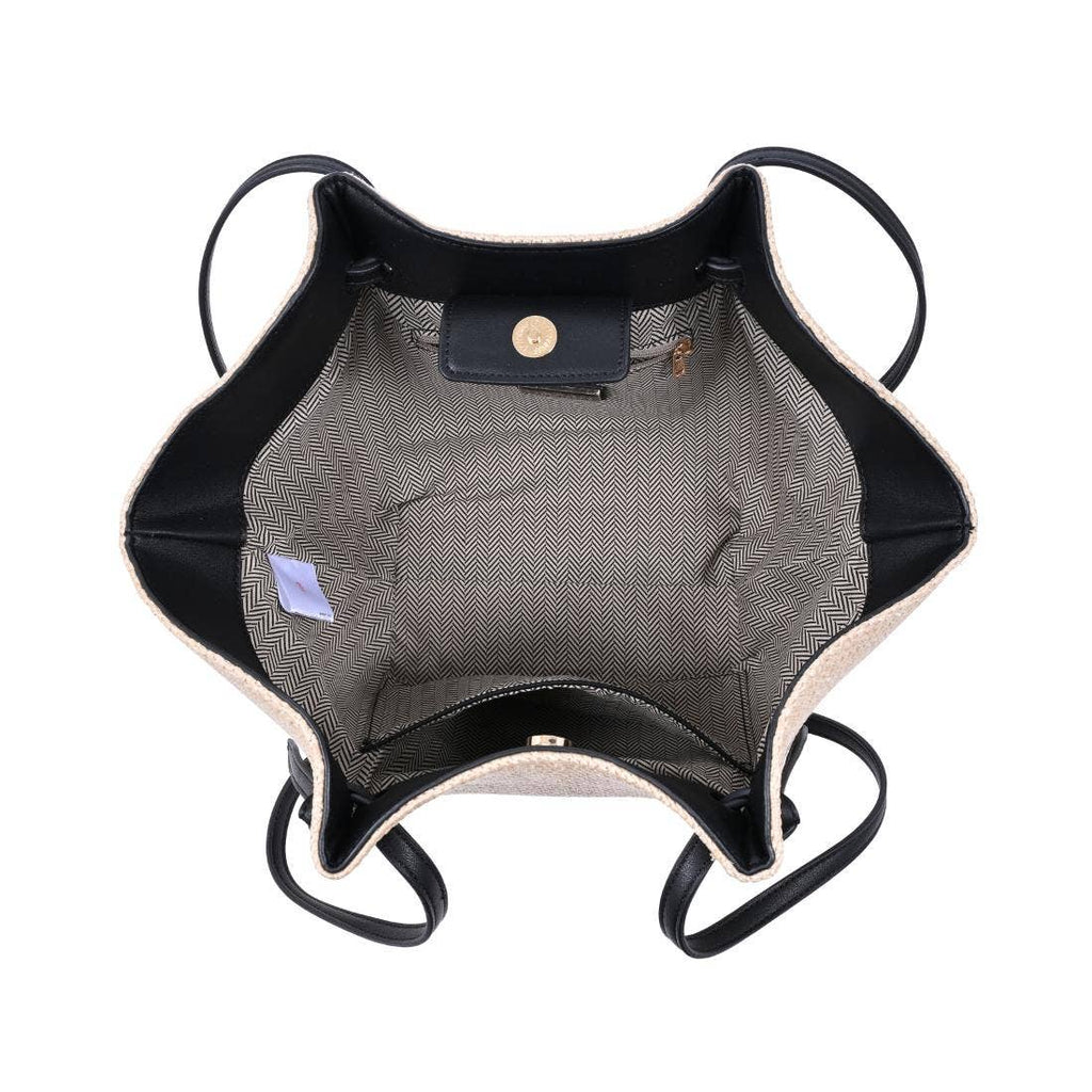 Inside fabric and pockets natural straw bag with black strap on a white background