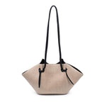 Natural straw bag with black strap on a white background