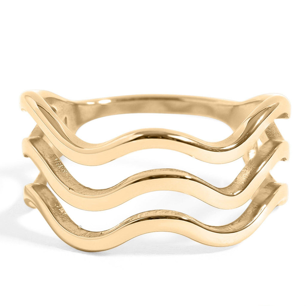 Gold ring with wavy design on a white background